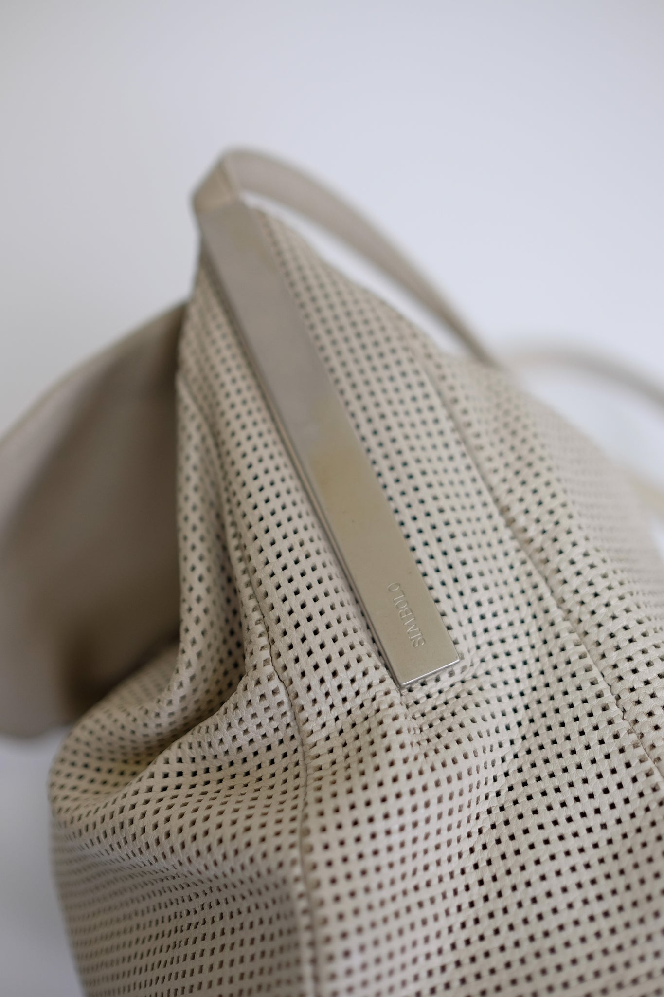 SIMBOLO PERFORATED LEATHER SHOULDER BAG IN OFF WHITE
