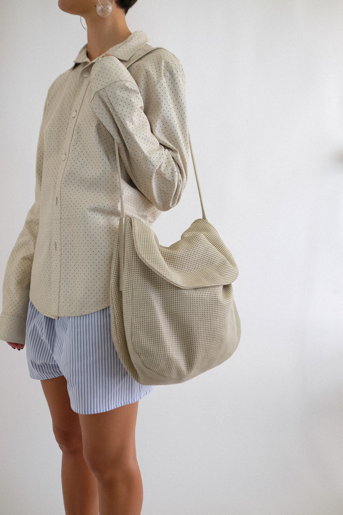 SIMBOLO PERFORATED LEATHER SHOULDER BAG IN OFF WHITE